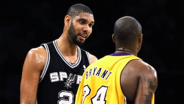 San Antonio Spurs' Tim Duncan (L) speaks with Los Angeles Lakers' Kobe Bryant after Bryant fouled him during the first half of an NBA basketball game in Los Angeles, February 3, 2011. REUTERS/Danny Moloshok (UNITED STATES - Tags: SPORT BASKETBALL)