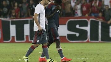 Olympiakos players Sasa Zdjelarin, left, and Ideye Brown leave the pitch dejected after losing to Hapoel Beer-Sheva Champions league qualifying match in Beersheba