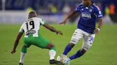 Atletico Nacional's defender Yerson Candelo (L) fights for the ball with Millonarios' midfielder Oscar Cortes (R) during the Colombian First Division Football Championship final match between Millonarios and Atletico Nacional at the El Campin stadium in Bogota, on June 24, 2023. (Photo by Raul ARBOLEDA / AFP)