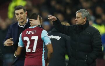 Manchester United manager Jose Mourinho gestures as West Ham United's Dimitri Payet hugs West Ham United manager Slaven Bilic