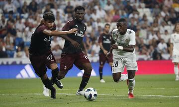 Vinicius (right) runs at the Milan defence.