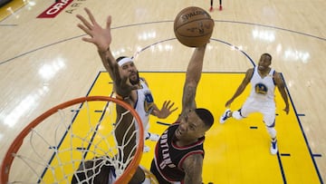 April 16, 2017; Oakland, CA, USA; Portland Trail Blazers guard Damian Lillard (0) drives to the basket against Golden State Warriors forward Draymond Green (23) and center JaVale McGee (1) during the first half in game one of the first round of the 2017 NBA Playoffs at Oracle Arena. The Warriors defeated the Trail Blazers 121-109. Mandatory Credit: Kyle Terada-USA TODAY Sports