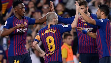 (L-R) Barcelona's Colombian defender Yerry Mina, Barcelona's Spanish midfielder Andres Iniesta, Barcelona's Spanish defender Gerard Pique and Barcelona's Uruguayan forward Luis Suarez celebrate a goal during the Spanish league football