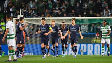 LISBON, PORTUGAL - FEBRUARY 15: Riyad Mahrez celebrates with teammates Kevin De Bruyne and John Stones of Manchester City after scoring their team&#039;s first goal during the UEFA Champions League Round Of Sixteen Leg One match between Sporting CP and Ma