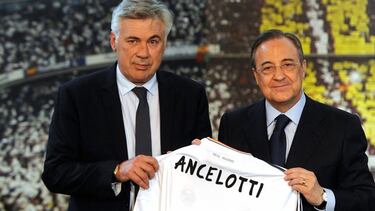 (FILES) In this file photo taken on June 26, 2013 new Real Madrid's Italian coach Carlo Ancelotti (L) poses with his new team's jersey flanked by Real Madrid's president Florentino Perez during his presentation at Santiago Bernabeu stadium,