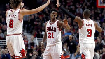 Chicago Bulls guard Jimmy Butler, center, celebrates with center Robin Lopez, left, and guard Dwyane Wade after scoring a basket during the second half of an NBA basketball game against the Washington Wizards in Chicago, Saturday, Nov. 12, 2016. The Bulls won 106-95. (AP Photo/Nam Y. Huh)