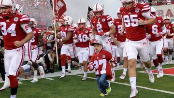 LINCOLN, NE - SEPTEMBER 03: A nephew of deceased player Sam Foltz wearing jersey #27 leads the Nebraska Cornhuskers onto the field before the game against the Fresno State Bulldogsat Memorial Stadium on September 3, 2016 in Lincoln, Nebraska. Nebraska defeated Fresno State 43-10.   Steven Branscombe/Getty Images/AFP
 == FOR NEWSPAPERS, INTERNET, TELCOS &amp; TELEVISION USE ONLY ==