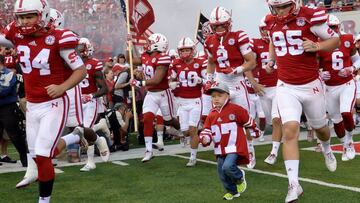 LINCOLN, NE - SEPTEMBER 03: A nephew of deceased player Sam Foltz wearing jersey #27 leads the Nebraska Cornhuskers onto the field before the game against the Fresno State Bulldogsat Memorial Stadium on September 3, 2016 in Lincoln, Nebraska. Nebraska defeated Fresno State 43-10.   Steven Branscombe/Getty Images/AFP
 == FOR NEWSPAPERS, INTERNET, TELCOS &amp; TELEVISION USE ONLY ==