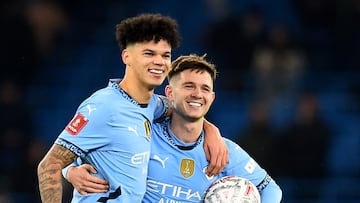 Soccer Football - FA Cup - Third Round - Manchester City v Salford City - Etihad Stadium, Manchester, Britain - January 11, 2025 Manchester City's James McAtee celebrates after the match with Nico O'Reilly while holding the match ball after scoring a hat-trick REUTERS/Peter Powell