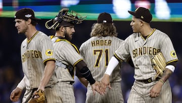 LOS ANGELES, CALIFORNIA - OCTOBER 12: Manny Machado #13 celebrates with Austin Nola #26 and Josh Hader #71 of the San Diego Padres after a 5-3 win over the Los Angeles Dodgers in game two of the National League Division Series at Dodger Stadium on October 12, 2022 in Los Angeles, California.   Ronald Martinez/Getty Images/AFP