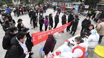 Residents line up for nucleic acid testing at a residential compound following new cases of the coronavirus disease (COVID-19) in Wuhan, Hubei province, China February 22, 2022. China Daily via REUTERS  ATTENTION EDITORS - THIS IMAGE WAS PROVIDED BY A THI