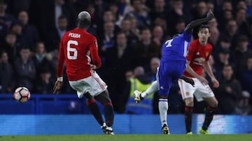 Pogba (left) looks on as Kanté (centre) fires in Chelsea's winner.