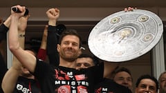 Bayer Leverkusen's Spanish head coach Xabi Alonso celebrates with a mock-up of the Bundesliga trophy with his players after the German first division Bundesliga football match Bayer 04 Leverkusen v Werder Bremen in Leverkusen, western Germany, on April 14, 2024. Bayer Leverkusen were crowned 2023-24 Bundesliga champions for the first time on April 14, 2024.� (Photo by INA FASSBENDER / AFP) / DFL REGULATIONS PROHIBIT ANY USE OF PHOTOGRAPHS AS IMAGE SEQUENCES AND/OR QUASI-VIDEO