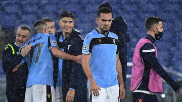 Lazio's Montenegrin midfielder Adam Marusic (2ndL) and Lazio's Argentine forward Joaquin Correa (4thL) celebrate at the end of the UEFA Champions League Group F football match Lazio Rome vs Club Brugge on December 8, 2020 at the Olympic stadium