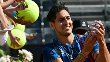 Chile's Alejandro Tabilo signs autographs and snaps selfies with fans after winning his match against Serbia's Novak Djokovic at the Men's ATP Rome Open tennis tournament at Foro Italico in Rome on May 12, 2024. (Photo by Tiziana FABI / AFP)