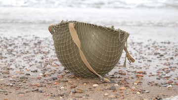 An American GI'S helmet on Omaha beach.