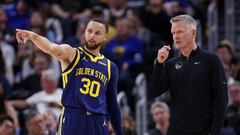 Stephen Curry #30 of the Golden State Warriors talks to head coach Steve Kerr