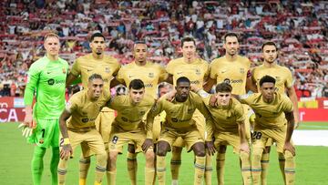 (From Top-L) Barcelona's German goalkeeper Marc-Andre ter Stegen, Barcelona's Uruguayan defender Ronald Araujo, Barcelona's French defender Jules Kounde, Barcelona's Polish forward Robert Lewandowski, Barcelona's Spanish midfielder Sergio Busquets, Barcelona's Spanish forward Eric Garcia, Barcelona's Brazilian forward Raphinha, Barcelona's Spanish midfielder Pedri, Barcelona's French forward Ousmane Dembele, Barcelona's Spanish midfielder Gavi and Barcelona's Spanish defender Alejandro Balde pose for a group picture before the start of the Spanish league football match between Sevilla FC and FC Barcelona at the Ramon Sanchez Pizjuan stadium in Seville, on September 2, 2022. (Photo by CRISTINA QUICLER / AFP)