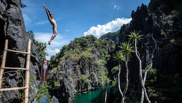 Oleksiy Prygorov of the Ukraine dives from a rock precipice at the Small Lagoon on Miniloc Island during the first competition day of the first stop of the Red Bull Cliff Diving World Series in Palawan, Philippines on April 12, 2019. // Dean Treml / Red Bull Content Pool // SI201904130503 // Usage for editorial use only //