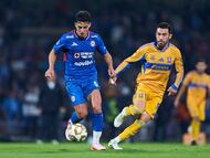 Lorenzo Faravelli (L) of Cruz Azul fights for the ball with Juan Pablo Vigon (R) of Tigres during the semi-finals first leg match between Cruz Azul and Tigres UANL, as part of the Liga BBVA MX, Torneo Apertura 2025 at Olimpico Universitario Stadium, on December 03, 2025 in Mexico City, Mexico.