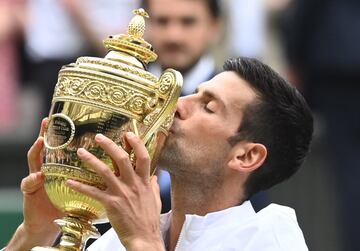 Tennis - Wimbledon - All England Lawn Tennis and Croquet Club, London, Britain - July 11, 2021 Serbia's Novak Djokovic celebrates with the trophy after winning his final match against Italy's Matteo Berrettini REUTERS/Toby Melville