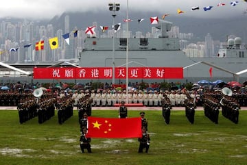 People's Liberation Army Navy soldiers take part in a parade with a banner "Wishing Hong Kong a Better Tomorrow", during an open day at a naval base in Hong Kong, China July 8, 2017.