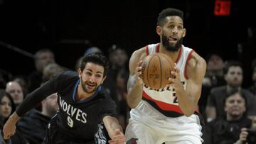 Minnesota Timberwolves guard Ricky Rubio reaches in to try and steal the ball from Portland Trail Blazers guard Allen Crabbe during the first half of an NBA basketball game in Portland, Ore., Thursday, April 6, 2017. (AP Photo/Steve Dykes)