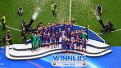 Barcelona players celebrate with their trophy after winning the UEFA Women's Champions League final football match between FC Barcelona and  Olympique Lyonnais at the San Mames stadium in Bilbao on May 25, 2024. (Photo by Ander Gillenea / AFP)