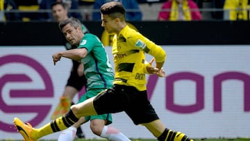 Marc Bartra keeps Bremen midfielder Fin Bartels in check in his first competitive return in today's final game of the season