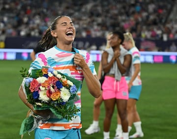 Morgan laughs after being sprayed with champagne following her final match before retirement.