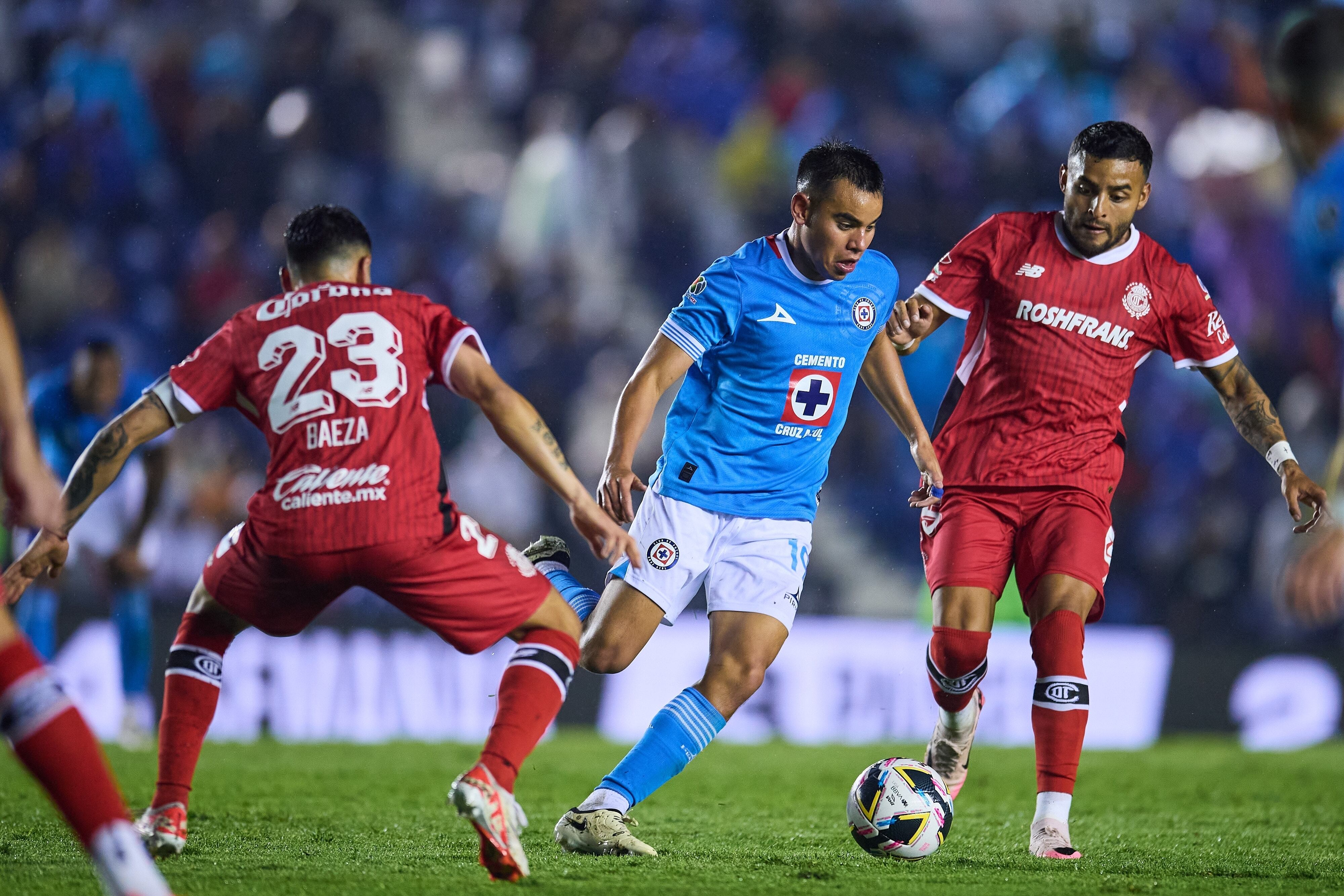 Carlos Rodriguez (L) of Cruz Azul fights for the ball with Alexis Vega (R) of Toluca during the 4th round match between Cruz Azul and Toluca as part of the Liga BBVA MX, Torneo Apertura 2024 at Ciudad de los Deportes Stadium on July 20, 2024 in Mexico City, Mexico.