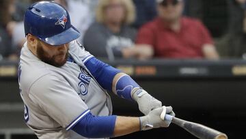 FILE - In this July 28, 2018, file photo, Toronto Blue Jays&#039; Russell Martin hits a solo home run against the Chicago White Sox during the third inning of a baseball game in Chicago. The Los Angeles Dodgers have reacquired catcher Martin in a trade with Toronto, a day after losing free agent Yasmani Grandal to Milwaukee. (AP Photo/Nam Y. Huh, File)