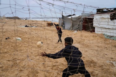 Niños palestinos desplazados juegan al fútbol en un campamento improvisado en Deir al-Balah, una ciudad palestina situada en el centro de la Franja de Gaza.