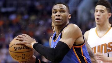 Oklahoma City Thunder guard Russell Westbrook (0) spins around Phoenix Suns guard Devin Booker during the first half of an NBA basketball game, Friday, April 7, 2017, in Phoenix. (AP Photo/Matt York)