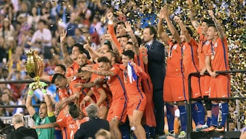 Chile's goalkeeper Claudio Bravo lifts the trophy after winning the Copa America Centenario final by defeating Argentina in the penalty shoot-out in East Rutherford, New Jersey, United States, on June 26, 2016.