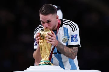 LUSAIL CITY, QATAR - DECEMBER 18: Alexis Mac Allister of Argentina celebrates with the trophy after the FIFA World Cup Qatar 2022 Final match between Argentina and France at Lusail Stadium on December 18, 2022 in Lusail City, Qatar. (Photo by Alex Livesey - Danehouse/Getty Images)