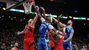 Toronto Raptors forward Juancho Hernangomez (41) and forward Chris Boucher (25) battle with Milwaukee Bucks forward Bobby Portis (9) and forward Sandro Mamukelashvili (54) for a rebound during the second half at Scotiabank Arena.