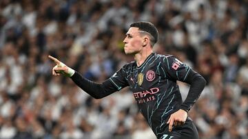 Manchester City's English midfielder #47 Phil Foden celebrates scoring his team's second goal during the UEFA Champions League quarter final first leg football match between Real Madrid CF and Manchester City at the Santiago Bernabeu stadium in Madrid on April 9, 2024. (Photo by JAVIER SORIANO / AFP)