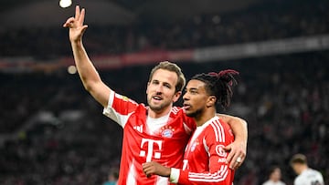 Bayern Munich's English forward #09 Harry Kane (L) celebrates with Bayern Munich's French midfielder #17 Michael Olise after scoring his side's 5th goal to complete his hat-trick during the German first division Bundesliga football match between VfB Stuttgart and Bayern Munich in Stuttgart on December 6, 2025. (Photo by THOMAS KIENZLE / AFP) / DFL REGULATIONS PROHIBIT ANY USE OF PHOTOGRAPHS AS IMAGE SEQUENCES AND/OR QUASI-VIDEO
