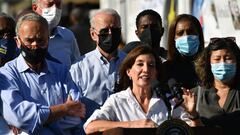 New York Governor Kathy Hochul (C) speaks, flanked by US Senator Chuck Schumer (L), New York Mayor Bill de Blasio (2nd L) and US President Joe Biden (3rd L), as the president tours a neighborhood affected by Hurricane Ida in Queens, New York on September 