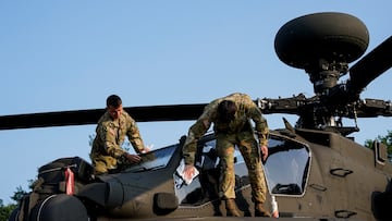 Members of the U.S. Army perform maintenance on a Boeing AH-64 Apache attack helicopter to be used in the U.S. Army's 250th Birthday Celebration and Parade, following landing on the National Mall in Washington, D.C., U.S., June 11, 2025. REUTERS/Al Drago