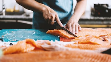 The chef is filleting fresh salmon in the kitchen high resolution stock photo