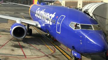 A Southwest Airline pilot checks his plane from the cockpit window at a gate of Ronald Reagan Washington National Airport in Arlington, Virginia on December 10, 2017