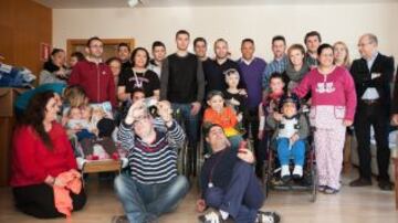 Iniesta y Adriano junto a otros personeros del Barcelona y varios niños del hospital.