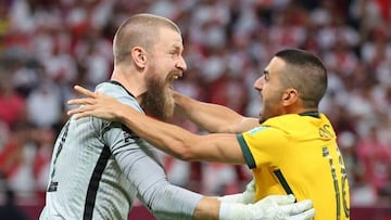 Australia's goalkeeper Andrew Redmayne (L) celebrates with Australia's defender Aziz Behich after winning the FIFA World Cup 2022 inter-confederation play-offs match between Australia and Peru on June 13, 2022, at the Ahmed bin Ali Stadium in the Qatari city of Ar-Rayyan. (Photo by KARIM JAAFAR / AFP) (Photo by KARIM JAAFAR/AFP via Getty Images)