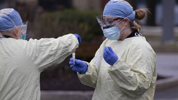Nurses handle a Covid-19 swab test at a drive through testing center in Massachusetts.