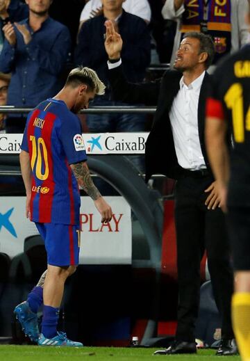 Lionel Messi leaves the pitch next to coach Luis Enrique.