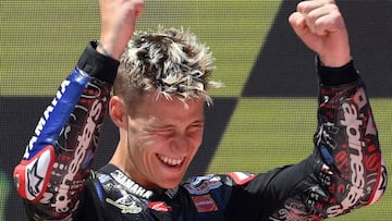 Yamaha French rider Fabio Quartararo celebrates on the podium after winning the Moto Grand Prix de Catalunya at the Circuit de Catalunya on June 5, 2022 in Montmelo on the outskirts of Barcelona. (Photo by LLUIS GENE / AFP)