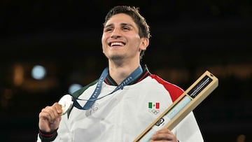 Silver medallist Mexico's Marco Alonso Verde Alvarez celebrates on the podium during the medal ceremony for the men's 71kg final boxing category during the Paris 2024 Olympic Games at the Roland-Garros Stadium, in Paris on August 9, 2024. (Photo by MOHD RASFAN / AFP)