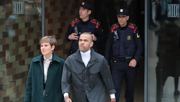 (FILES) Convicted rapist and former Brazil international football player Dani Alves (R) leaves on provisional release, flanked by his lawyer Ines Guardiola, at Brians 2 prison in San Esteban Sasroviras, near Barcelona, on March 25, 2024. A Spanish appeals court overturned on March 28, 2025 former Brazil international footballer Dani Alves' rape conviction, arguing his trial was marked by "shortcomings" and "inaccuracies". Alves was sentenced to four-and-a-half years in jail in February last year for raping a young woman in the VIP bathroom of a Barcelona nightclub on December 31, 2022. (Photo by LLUIS GENE / AFP)